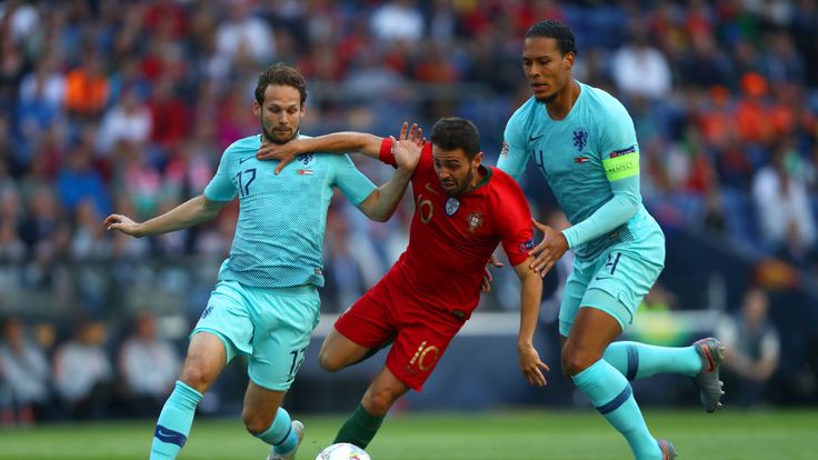 Portugal's Bernardo Silva shields the ball from Netherlands defenders Daley Blind and Virgil van Dijk
