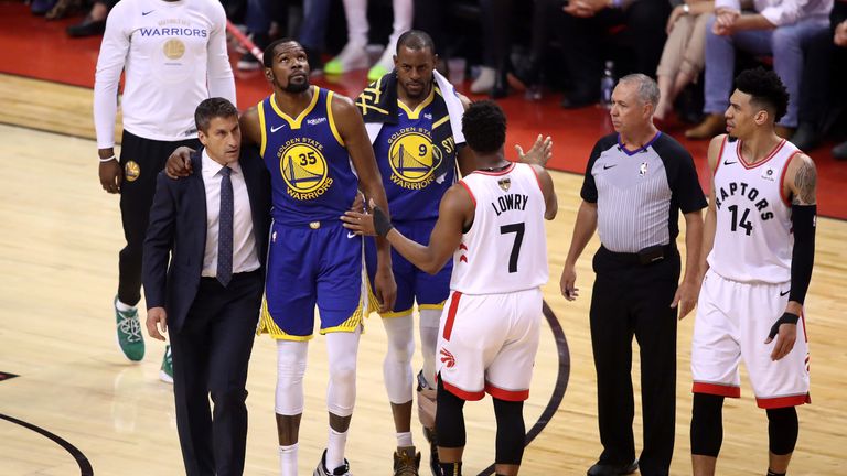 Kevin Durant is helped from the court after suffering an Achilles injury in Game 5 of the NBA Finals
