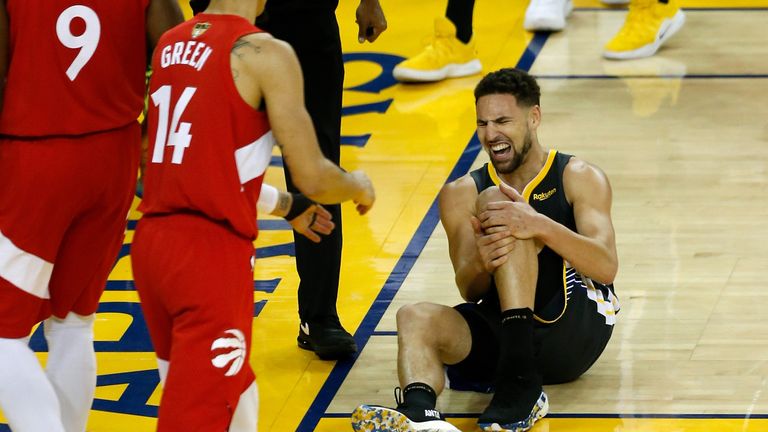 Klay Thompson clutches his knee after being fouled attempting a dunk in Game 6 of the NBA Finals
