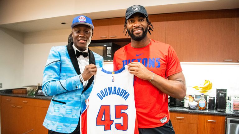 Sekou Doumbouya meets new team-mate Andre Drummond at the Pistons training facility