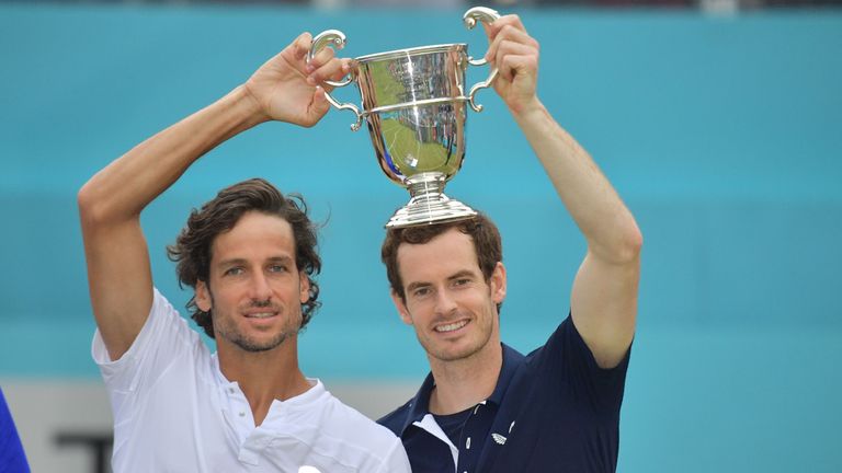 Andy Murray (R) and Spain's Feliciano Lopez pose with the trophy after their win in the men's doubles final tennis match against US player Rajeev Ram and Britain's Joe Salisbury at the ATP Fever-Tree Championships tournament at Queen's Club in west London on June 23, 2019