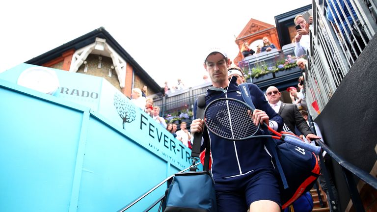 Andy Murray of Great Britain walks onto centre court with his playing partner Feliciano Lopez of Spain prior to their First Round Doubles match against Juan Sebastian Cabal and Robert Farah of Colombia during day Four of the Fever-Tree Championships at Queens Club on June 20, 2019 in London, United Kingdom