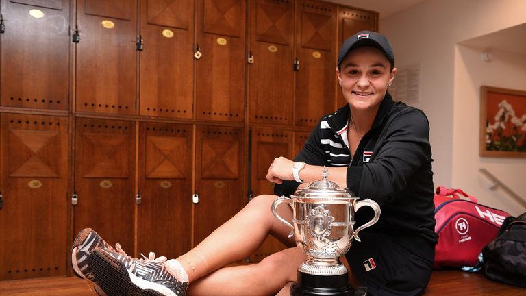 Ashleigh Barty of Australia celebrates victory with the winners trophy in the dressing room following the ladies singles final match against Marketa Vondrousova of The Czech Republic during Day fourteen of the 2019 French Open at Roland Garros on June 08, 2019 