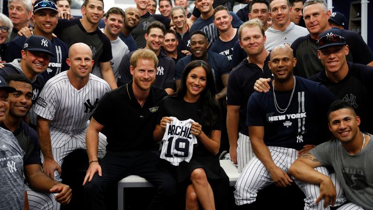 Prince Harry, Duke of Sussex and Meghan, Duchess of Sussex pose for a photo with the New York Yankees before their game against the Boston Red Sox at London Stadium on June 29, 2019