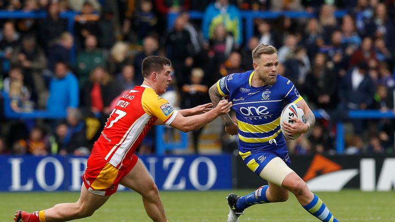 Warrington Wolves' Blake Austin skips away from Catalans Dragons' Matt Whitley during the Betfred Super League match at The Halliwell Jones Stadium, Warrington. PRESS ASSOCIATION Photo. Picture date: Saturday June 8, 2019. See PA story RUGBYL Warrington. Photo credit should read: Martin Rickett/PA Wire. RESTRICTIONS: Editorial use only. No commercial use. No false commercial association. No video emulation. No manipulation of images.