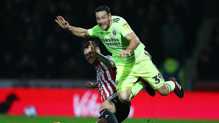 Conor Washington (r) is tackled by Josh McEachran