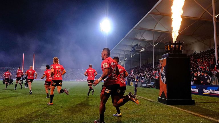 Crusaders players run onto the field before the Super Rugby semi-final match between New Zealand's Crusaders and Hurricanes in Christchurch on June 29, 2019. (Photo by Marty MELVILLE / AFP) (Photo credit should read MARTY MELVILLE/AFP/Getty Images)