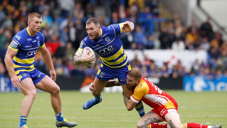 Warrington Wolves' Daryl Clark is tackled by Catalans Dragons' Sam Tomkins, during the Betfred Super League match at The Halliwell Jones Stadium, Warrington. PRESS ASSOCIATION Photo. Picture date: Saturday June 8, 2019. See PA story RUGBYL Warrington. Photo credit should read: Martin Rickett/PA Wire. RESTRICTIONS: Editorial use only. No commercial use. No false commercial association. No video emulation. No manipulation of images.