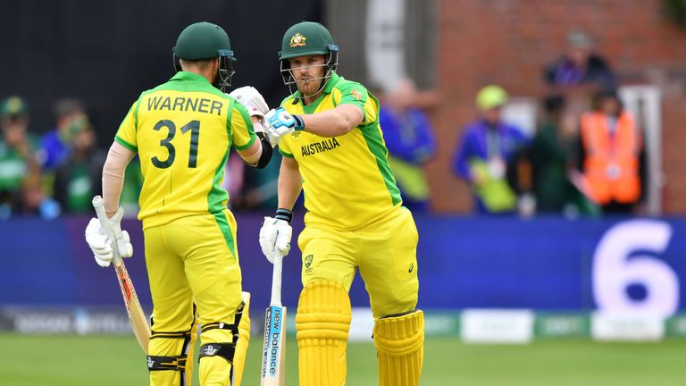 David Warner (L) and Australia's captain Aaron Finch touch gloves after a boundary against Pakistan