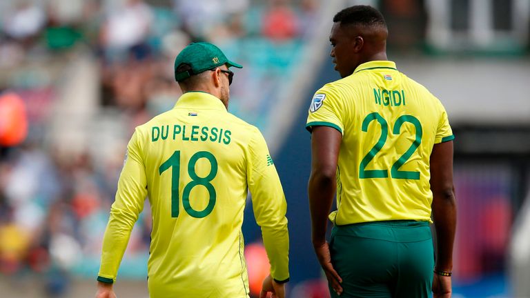 South Africa's captain Faf du Plessis (L) speaks with South Africa's Lungi Ngidi as he walks back to his mark after a delivery during the 2019 Cricket World Cup group stage match between South Africa and Bangladesh at The Oval in London on June 2, 2019. 