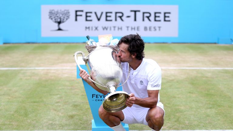 Feliciano Lopez of Spain celebrates victory as he kisses the trophy during the mens singles final against Gilles Simon of France during day seven of the Fever-Tree Championships at Queens Club on June 23, 2019 in London, United Kingdom. 