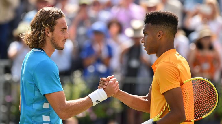 Canada's Felix Auger Aliassime (R) shakes hands with Greece's Stefanos Tsitsipas (L) after winning their men's singles quarter final tennis match at the ATP Fever-Tree Championships tournament at Queen's Club in west London on June 21, 2019