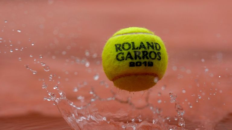 A 2019 French Open tennis tournament official ball bounces on a cover as rain falls on day eleven of The Roland Garros 2019 French Open tennis tournament in Paris on June 5, 2019.