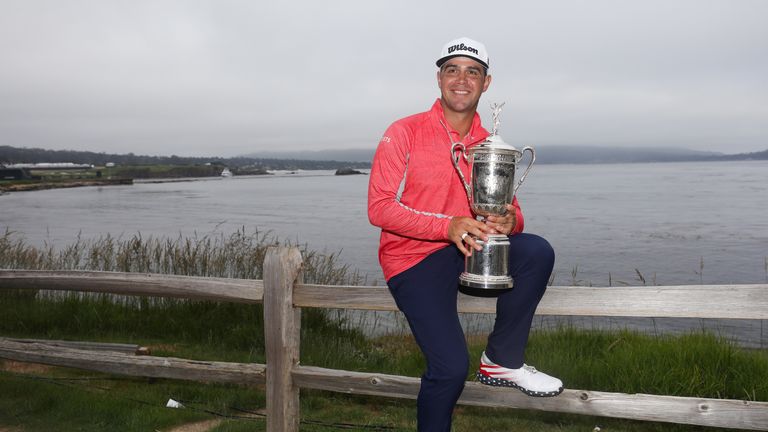 Gary Woodland poses with the US Open trophy after winning on 13 under