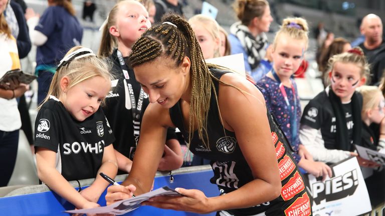 Geva Mentor signs an autograph for a fan