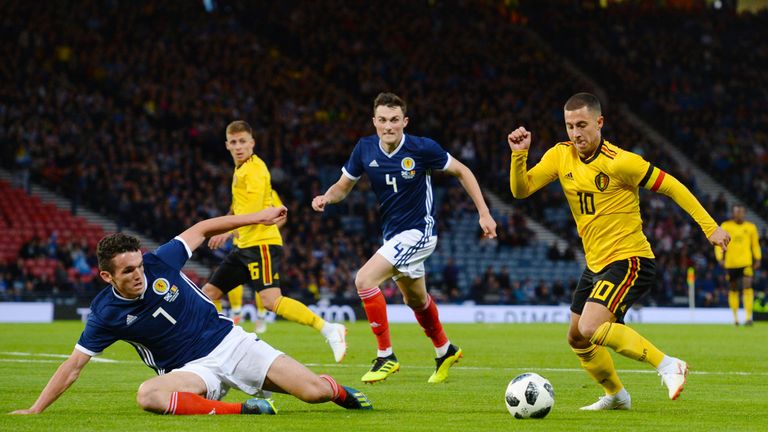 Scotland's John McGinn  pursues Belgium's Eden Hazard