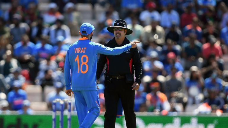 India's Virat Kohli talks to umpire Richard Illingworth after an unsuccessful review decision against Afghanistan.