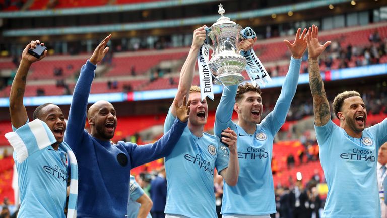 John Stones and Kevin De Bruyne celebrate Manchester City winning the FA Cup