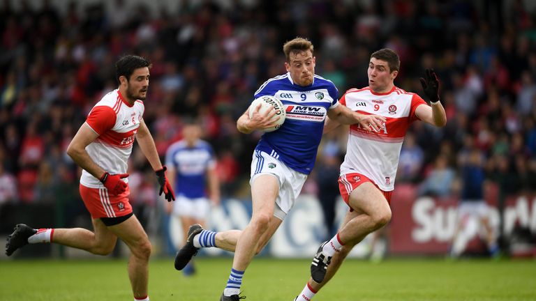 Kieran Lillis of Laois takes on Ciaran McFaul of Derry