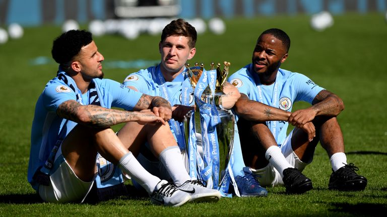 MANCHESTER, ENGLAND - MAY 06: Kyle Walker of Manchester City , John Stones of Manchester City and Raheem Sterling of Manchester City celebrates with The Premier League Trophy after the Premier League match between Manchester City and Huddersfield Town at Etihad Stadium on May 6, 2018 in Manchester, England. (Photo by Shaun Botterill/Getty Images)