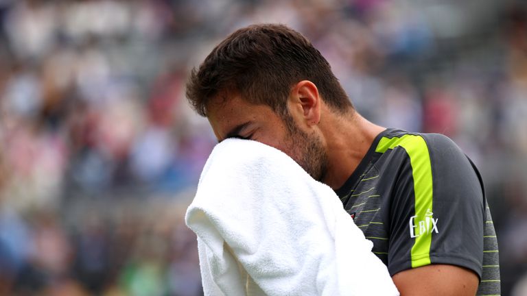 Marin Cilic of Croatia wipes his face with a towel during his Second Round Singles Match against Diego Schwartzman of Argentina during day Four of the Fever-Tree Championships at Queens Club on June 20, 2019 in London, United Kingdom