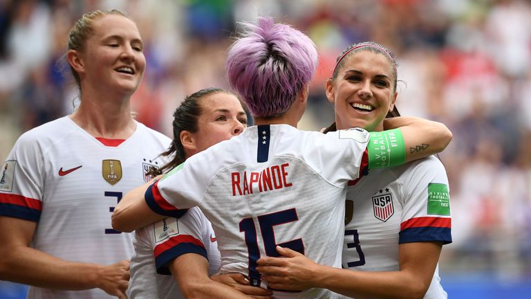 Rapinoe celebrates with team-mates after her first penalty in the seventh minute