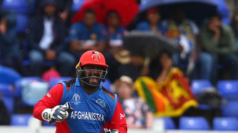 Mohammad Shahzad celebrates Sri Lanka's Kusal Perera's dismissal for 78 during the 2019 Cricket World Cup group stage match between Afghanistan and Sri Lanka at Sophia Gardens stadium in Cardiff, south Wales, on June 4, 2019.
