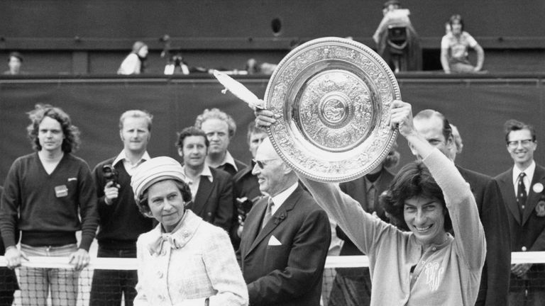 Queen Elizabeth II watches as the Women's Singles Champion, Virginia Wade from Britain, shows her trophy to the crowd on the centre court at Wimbledon, 1st July 1977. Wade has just beaten Betty Stove of the Netherlands in the final.