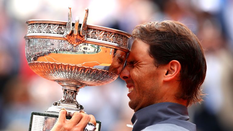 Rafael Nadal of Spain celebrates with the trophy following the mens singles final against Dominic Thiem of Austria during Day fifteen of the 2019 French Open at Roland Garros on June 09, 2019 in Paris, France