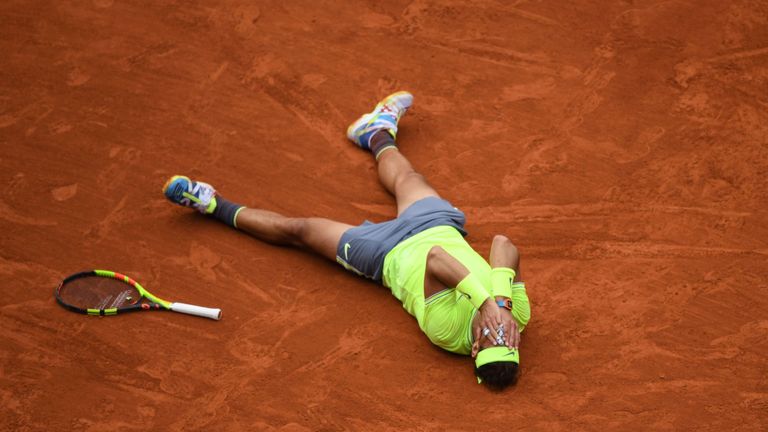 Spain's Rafael Nadal celebrates after winning against Austria's Dominic Thiem during their men's singles final match, on day fifteen of The Roland Garros 2019 French Open tennis tournament in Paris on June 9, 2019.