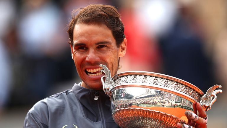 Rafael Nadal of Spain bites the winners trophy after victory following the mens singles final against Dominic Thiem of Austria during Day fifteen of the 2019 French Open at Roland Garros on June 09, 2019 in Paris, France.