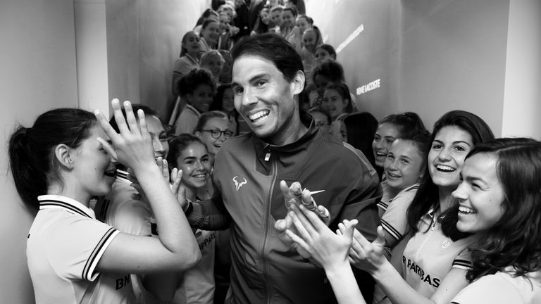 Rafael Nadal of Spain leaves the court as he is congratulated on victory from the ball boys and girls following the mens singles final against Dominic Thiem of Austria during Day fifteen of the 2019 French Open at Roland Garros on June 09, 2019 in Paris, France