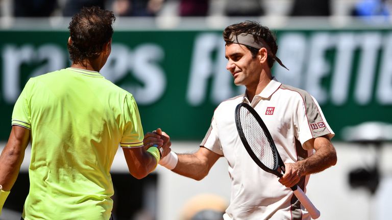 Roger Federer congratulates Rafael Nadal at the net 