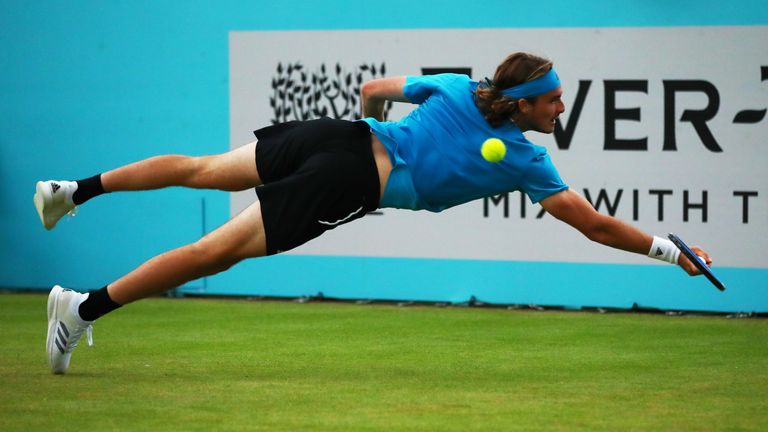 Stefanos Tsitsipas of Greece dives to play a backhand during his First Round Singles Match against Kyle Edmund of Great Britain during day Three of the Fever-Tree Championships at Queens Club on June 19, 2019 in London, United Kingdom.