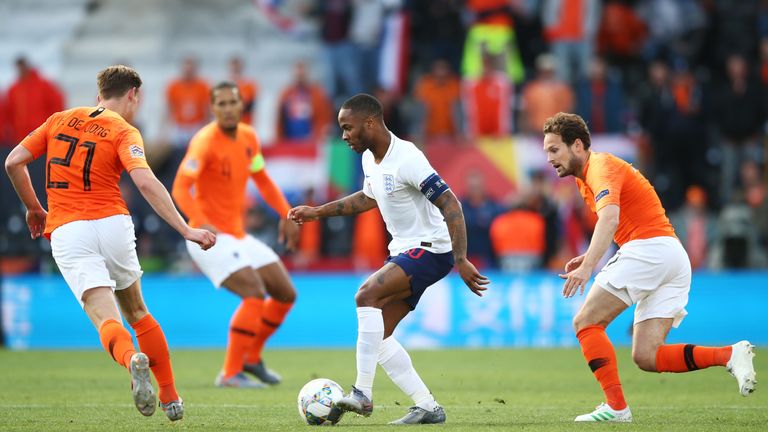Raheem Sterling is surrounded by Dutch players