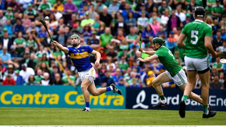 Noel McGrath evades William O'Donoghue