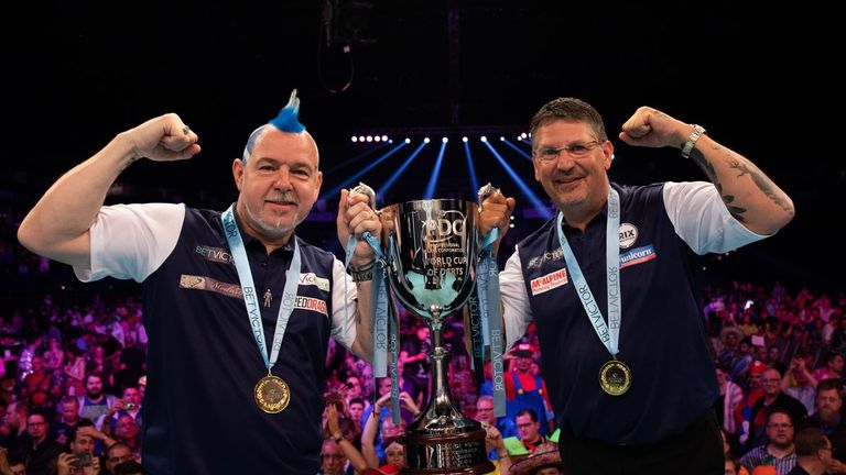 Peter Wright and Gary Anderson celebrate winning a first World Cup of Darts title