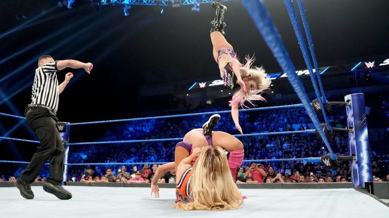 Alex Bliss hits the Twisted Bliss whilst Charlotte Flair holds Carmella in the Figure 8