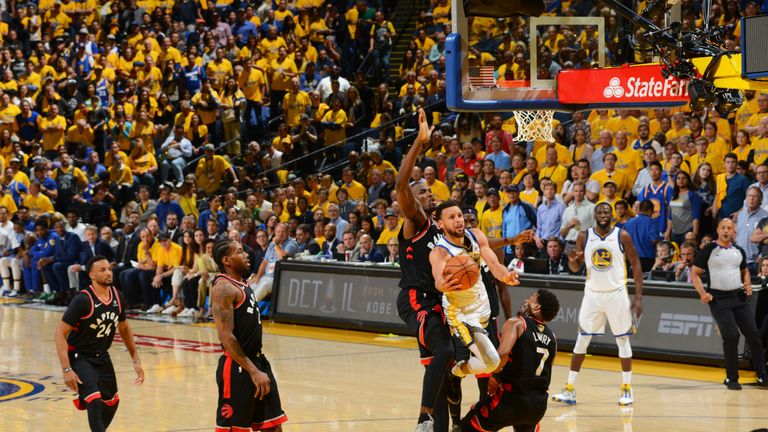 Stephen Curry fights his way to the basket during Game 3