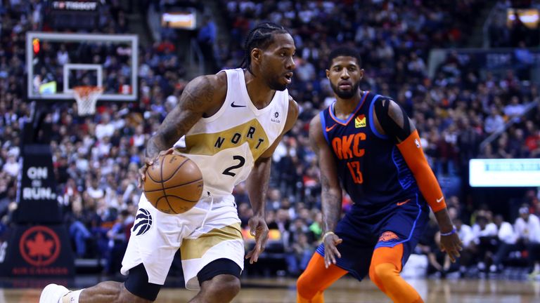 Kawhi Leonard is guarded by Paul George