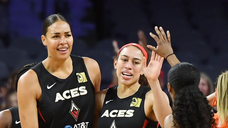  Liz Cambage, Dearica Hamby and Sydney Colson of the Las Vegas Aces celebrate on the court 
