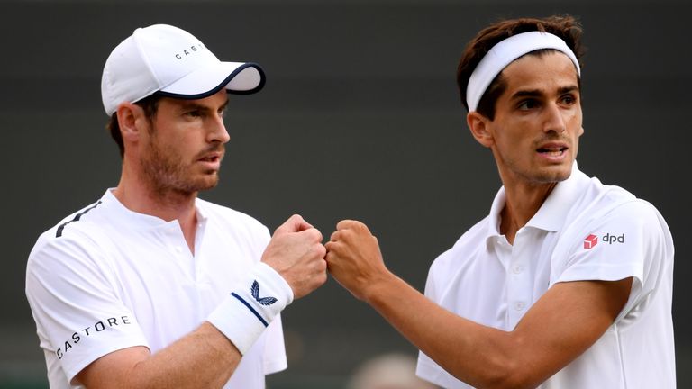 Andy Murray of Great Britain speaks with playing partner Pierre-Hughes Herbert of France during their Men's Doubles first round match against Marius Copil of Romania and Ugo Humbert of France during Day four of The Championships - Wimbledon 2019 at All England Lawn Tennis and Croquet Club on July 04, 2019 in London, England.