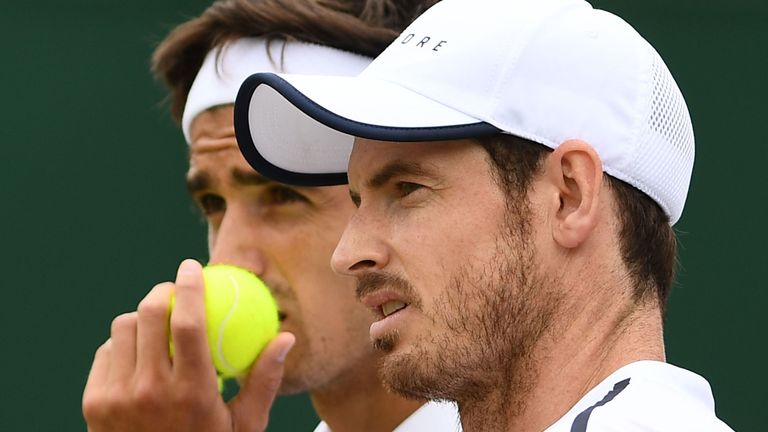 France's Pierre-Hugues Herbert (L) and Britain's Andy Murray (R) talk between points against Croatia's Nikola Mektic and Croatia's Franko Skugor during their men's doubles second round match on the sixth day of the 2019 Wimbledon Championships at The All England Lawn Tennis Club in Wimbledon, southwest London, on July 6, 2019.