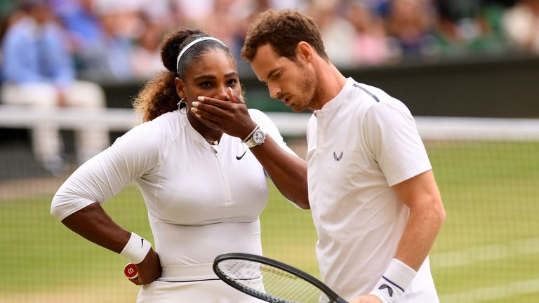 Britain's Andy Murray (R) and US player Serena Williams (L) touch hands between points against Germany's Andreas Mies and Chile's Alexa Guarachi during their mixed doubles first round match on the sixth day of the 2019 Wimbledon Championships at The All England Lawn Tennis Club in Wimbledon, southwest London, on July 6, 2019