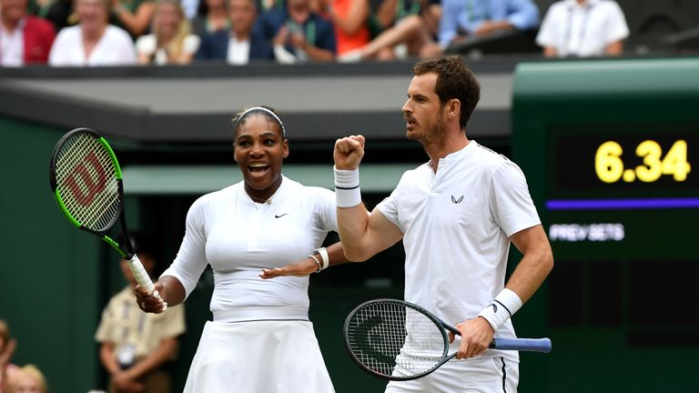 Andy Murray (R) and US player Serena Williams (L) celebrate winning a point against France's Fabrice Martin and US player Raquel Atawo during their mixed doubles second round match on day eight of the 2019 Wimbledon Championships at The All England Lawn Tennis Club in Wimbledon, southwest London, on July 9, 2019.