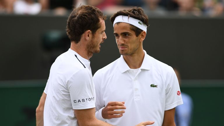 Britain's Andy Murray (L) and his partner France's Pierre-Hugues Herbert (R) reacts after losing to Croatia's Nikola Mektic and Croatia's Franko Skugor during their men's doubles second round match on the sixth day of the 2019 Wimbledon Championships at The All England Lawn Tennis Club in Wimbledon, southwest London, on July 6, 2019