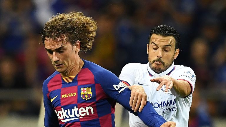 Barcelona forward Antoine Griezmann battles Pedro for the ball
