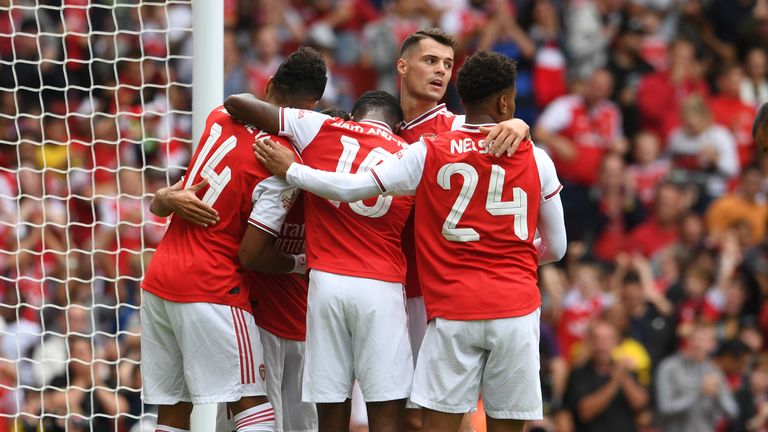 Arsenal players celebrate their opener at the Emirates