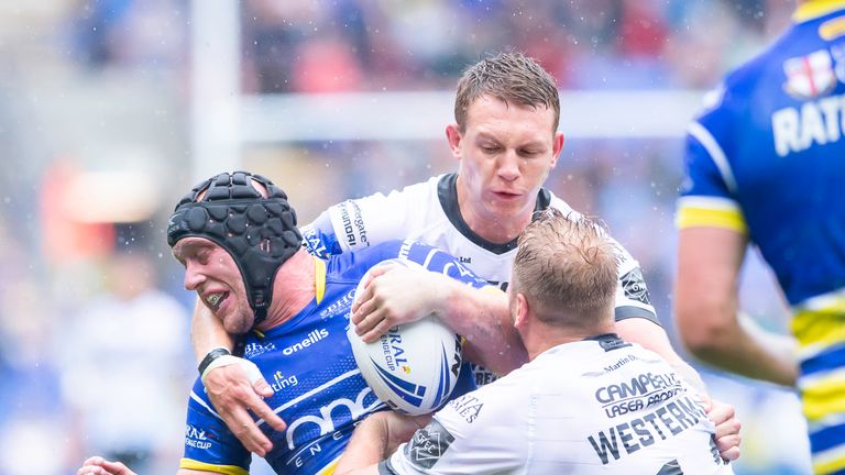 Warrington's Chris Hill is tackled by Hull FC's Jordan Lane & Joe Westerman.