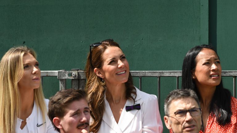 Catherine, Duchess of Cambridge (C) smiles on Court 14 as she watches Britain's Harriet Dart playing against US player Christina McHale at The All England Tennis Club in Wimbledon, southwest London, on July 2, 2019, on the second day of the 2019 Wimbledon Championships tennis tournament.